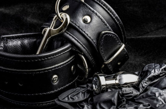 Black leather cuffs on a black background.