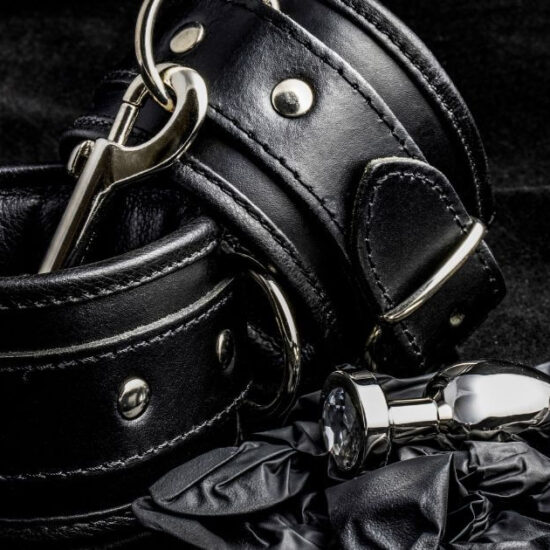 Black leather cuffs on a black background.