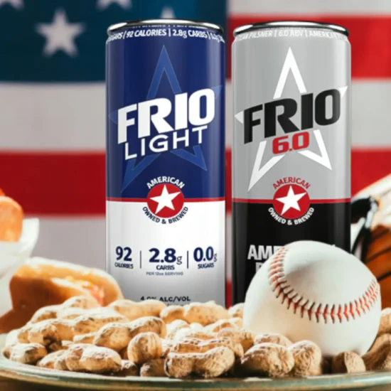 Two cans of Frio Beer, a plate of peanuts, a baseball, and hot dogs in front of an American flag.